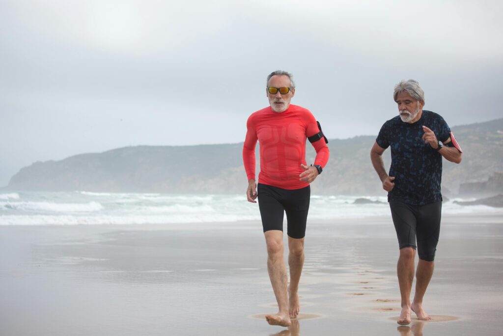 2 men jogging on beach